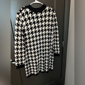 Patterned black and white dress with gold button on shoulder